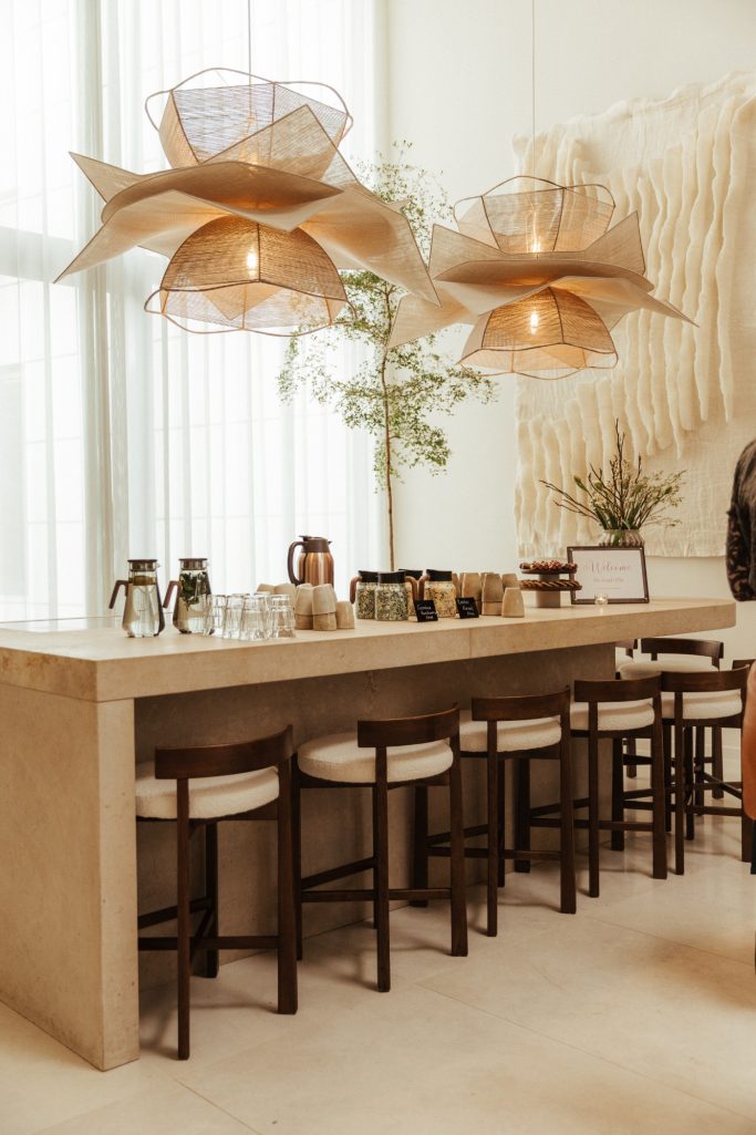 Moderne bar met natuurstenen oppervlak, stijlvolle barkrukken en hanglampen.